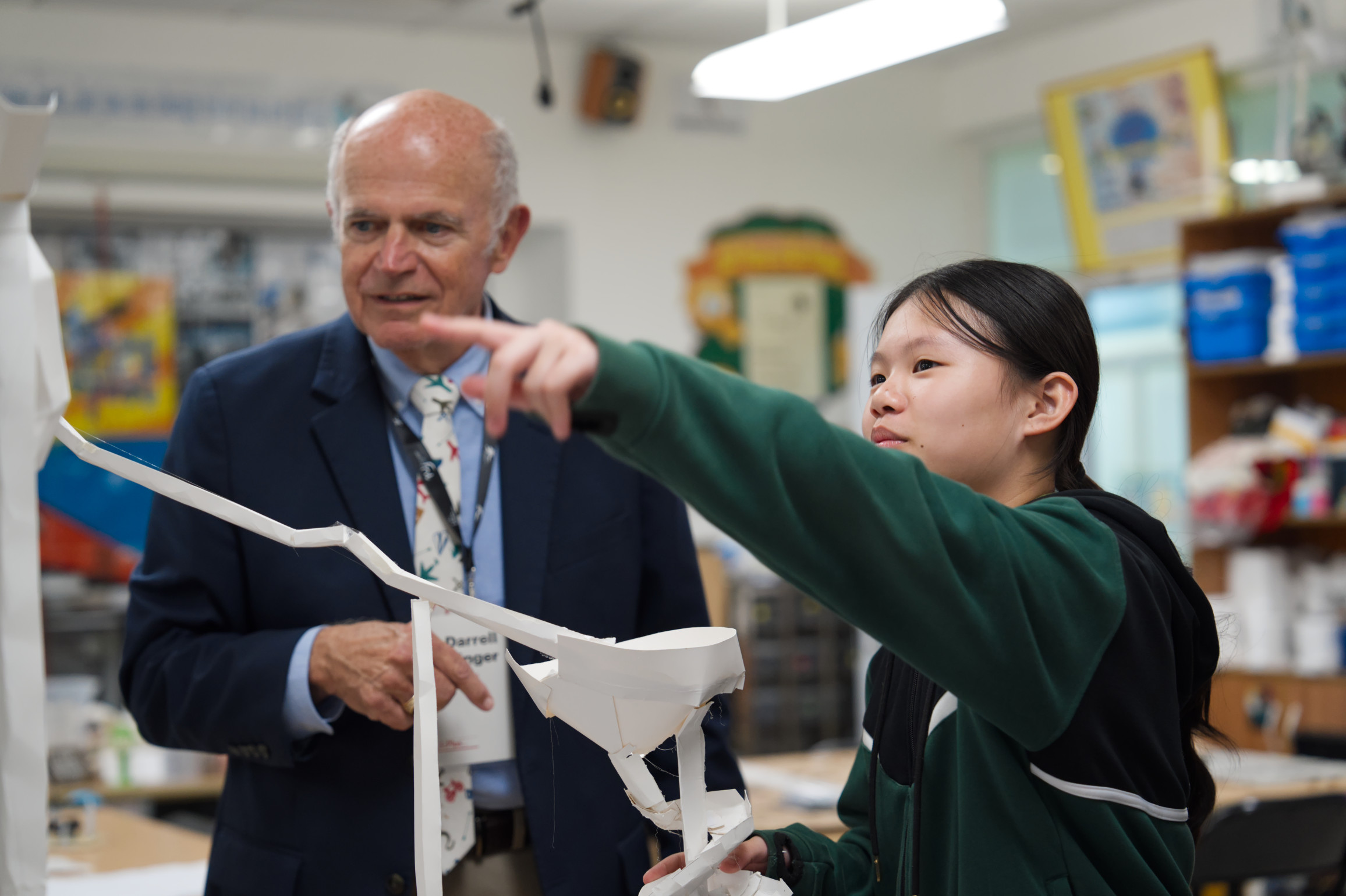A Cognia accreditation review team member interacting with a student at wuhan yangtze international school.